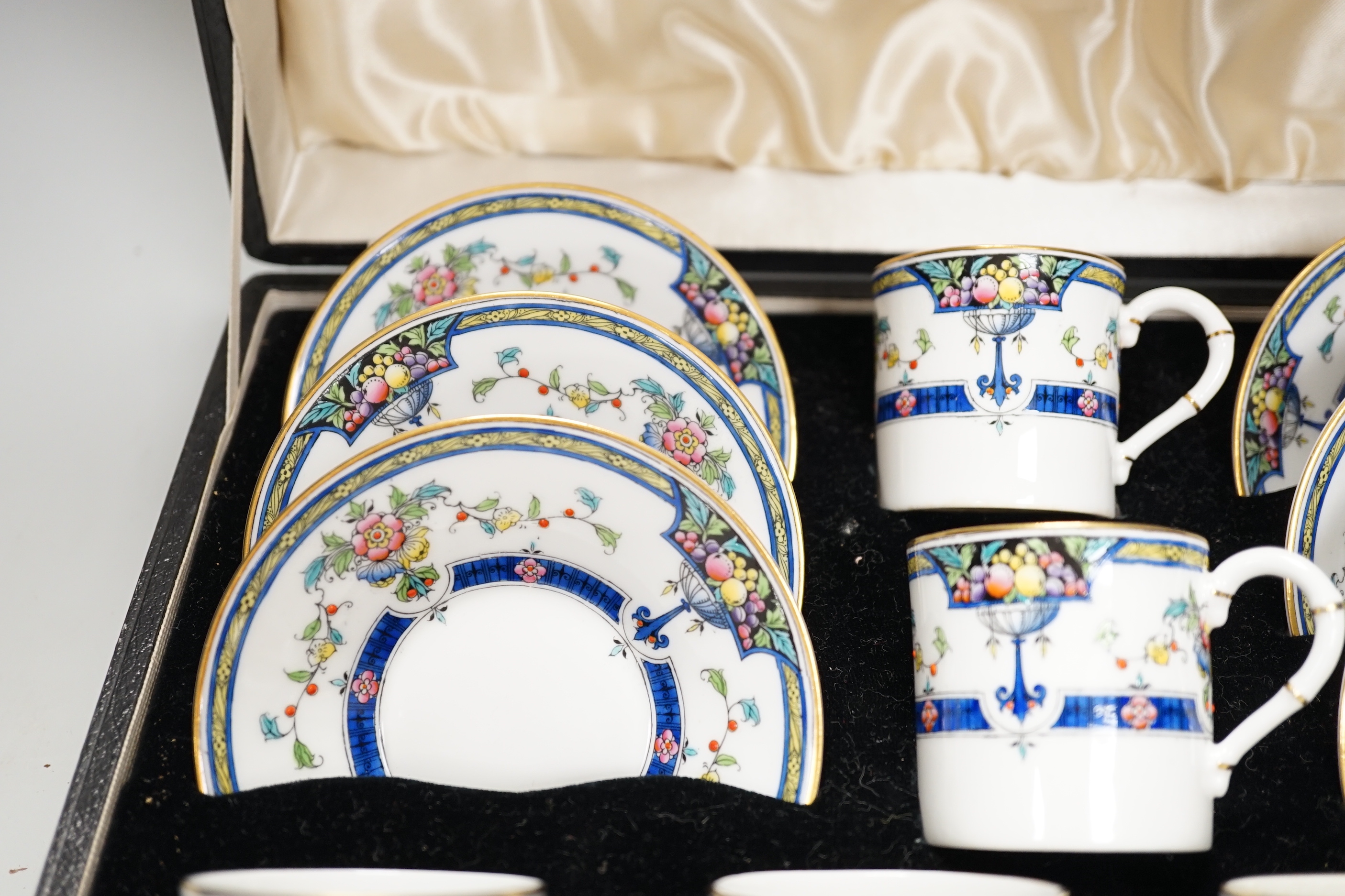A cased Royal Worcester ‘Orlando’ coffee set with silver spoons